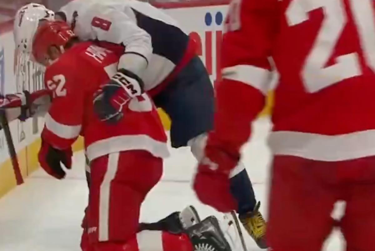 Alex Ovechkin helping Travis Hamonic.