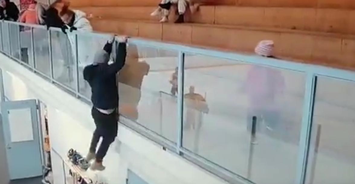 Crazed hockey fan jumps over the glass to attack a player.