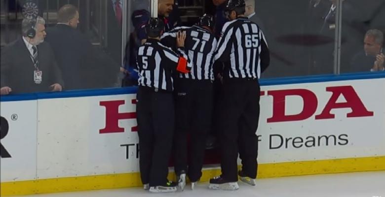 VIDEO: Linesman knocked out of the game after getting crushed by two players.