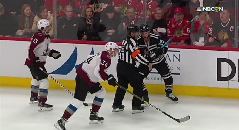 Jonathan Toews nearly slashes referee Justin St. Pierre in frustration.