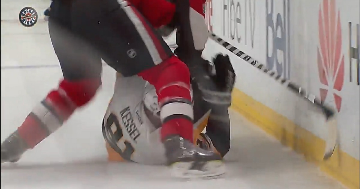 Dion Phaneuf drives former teammate Phil Kessel hard into the boards.