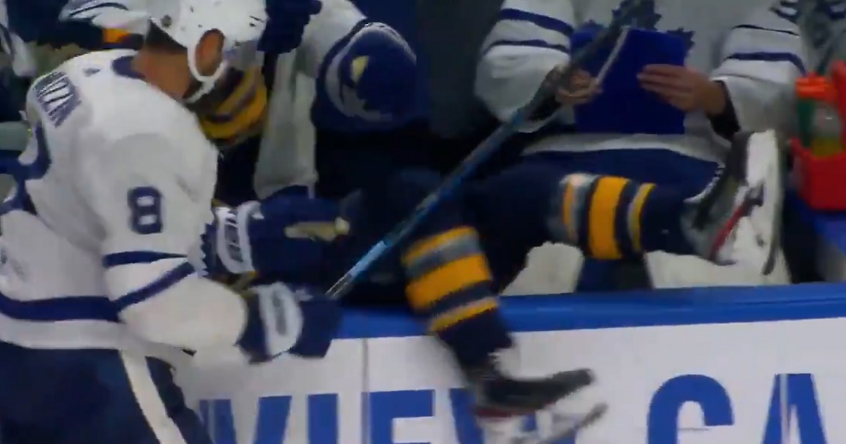 Muzzin dumps Olofsson into the Maple Leafs bench.