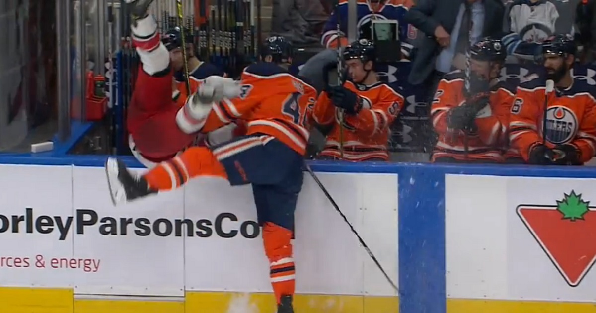 Kassian sends Martinook into the Oilers bench with a big hit!