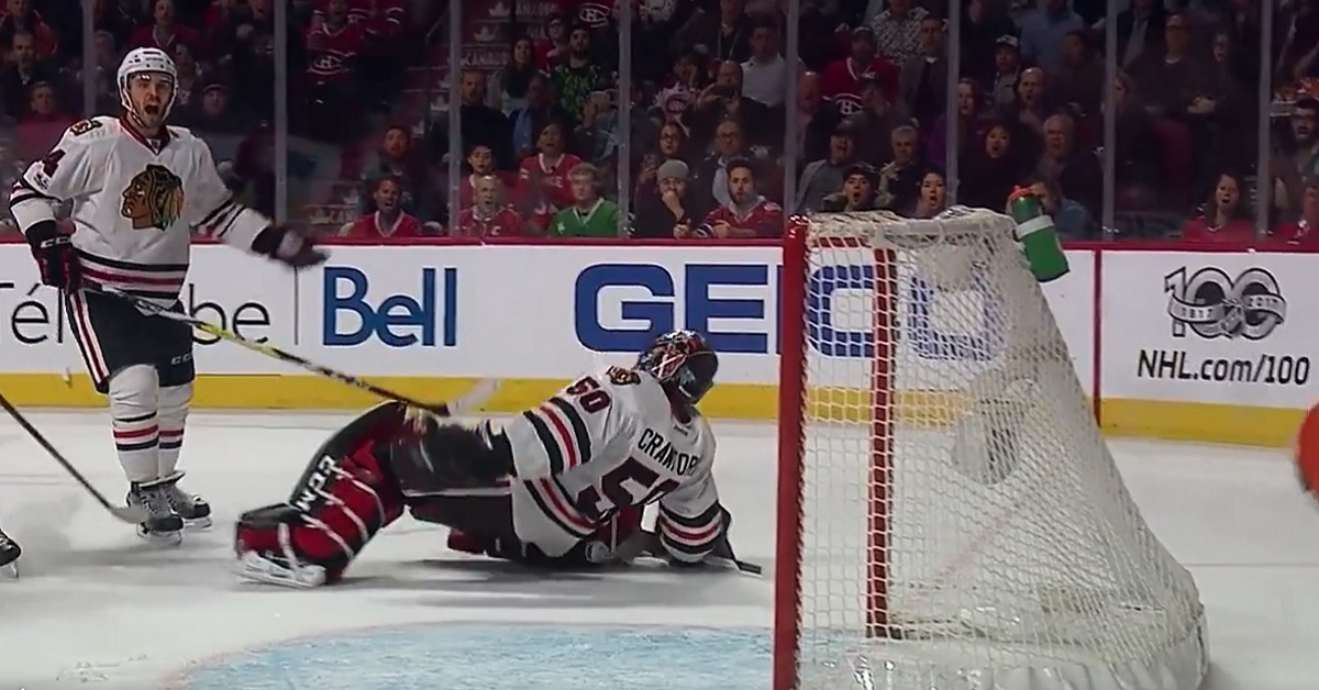 Corey Crawford gets rocked by a headshot from Shea Weber.
