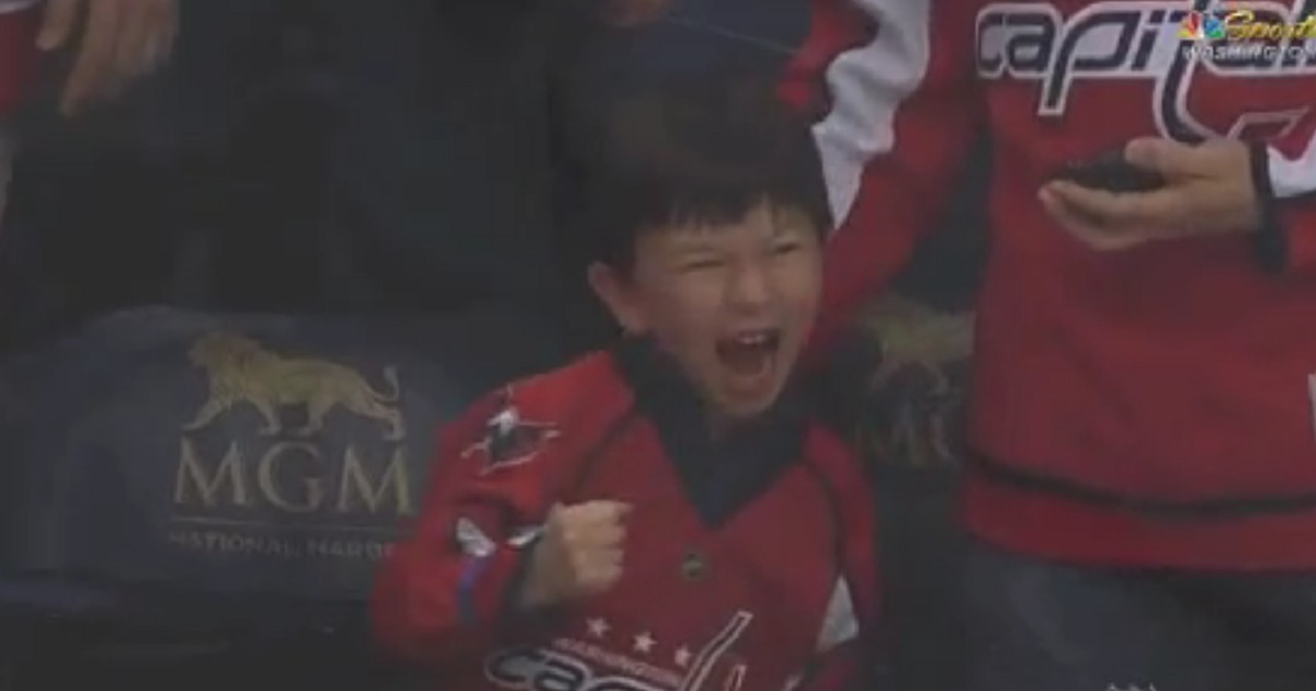 Backstrom gives puck to a young fan, his reaction is unforgettable. 