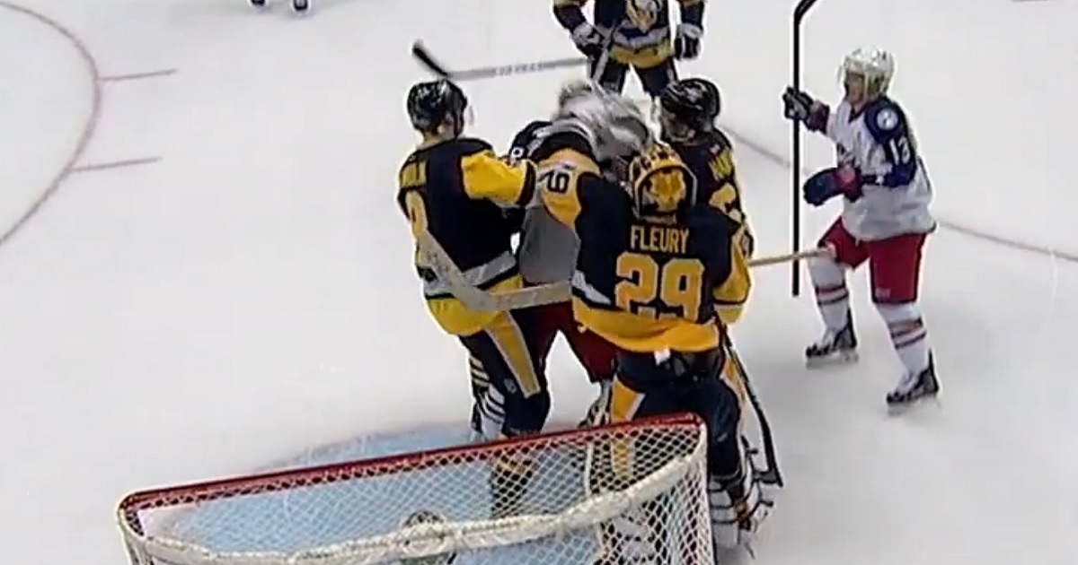 Fleury throws a punch after being slash in front of his net.