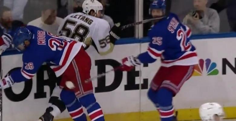 Kris Letang delivers a hard slash to the face of his opponent.