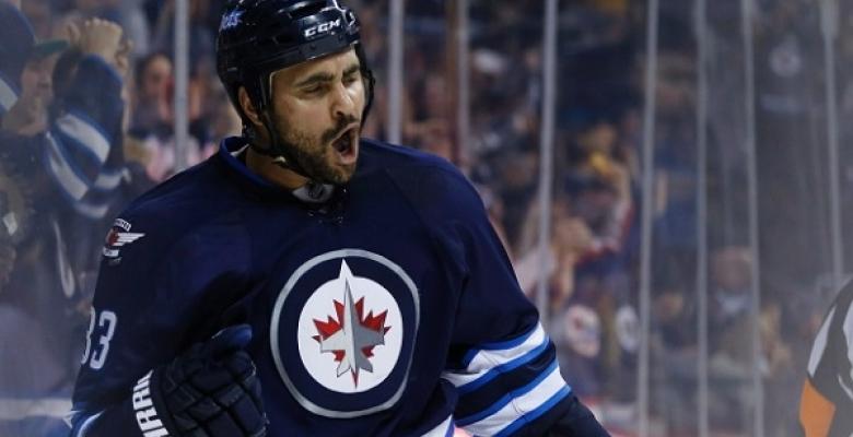VIDEO: Dustin Byfuglien dumps Fleischmann into the Jets bench!