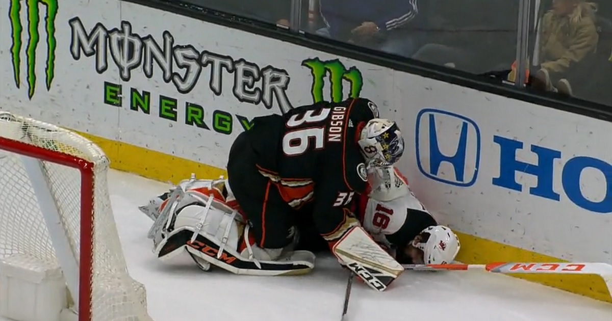 Ducks goalie John Gibson levels Kevin Rooney and then adds some trash talk for good measure.