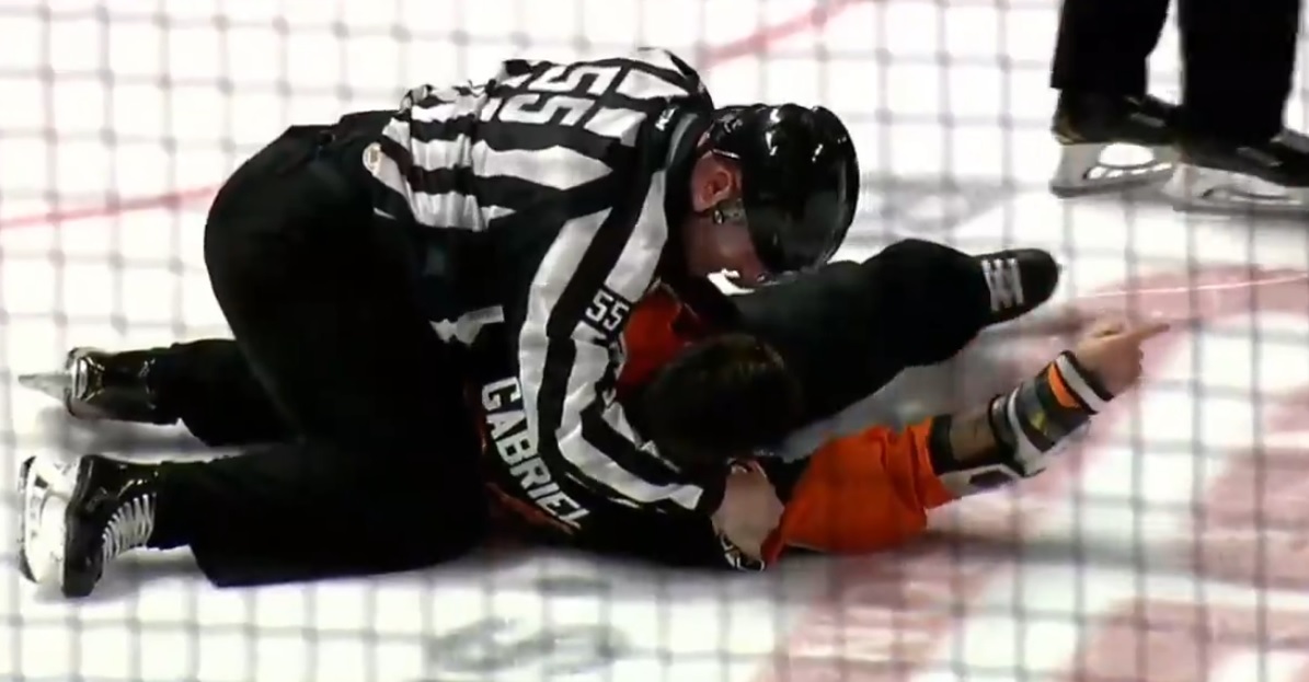 Linesman Richard Jondo slams Kurtis Gabriel to the ice after he refuses to stop fighting.