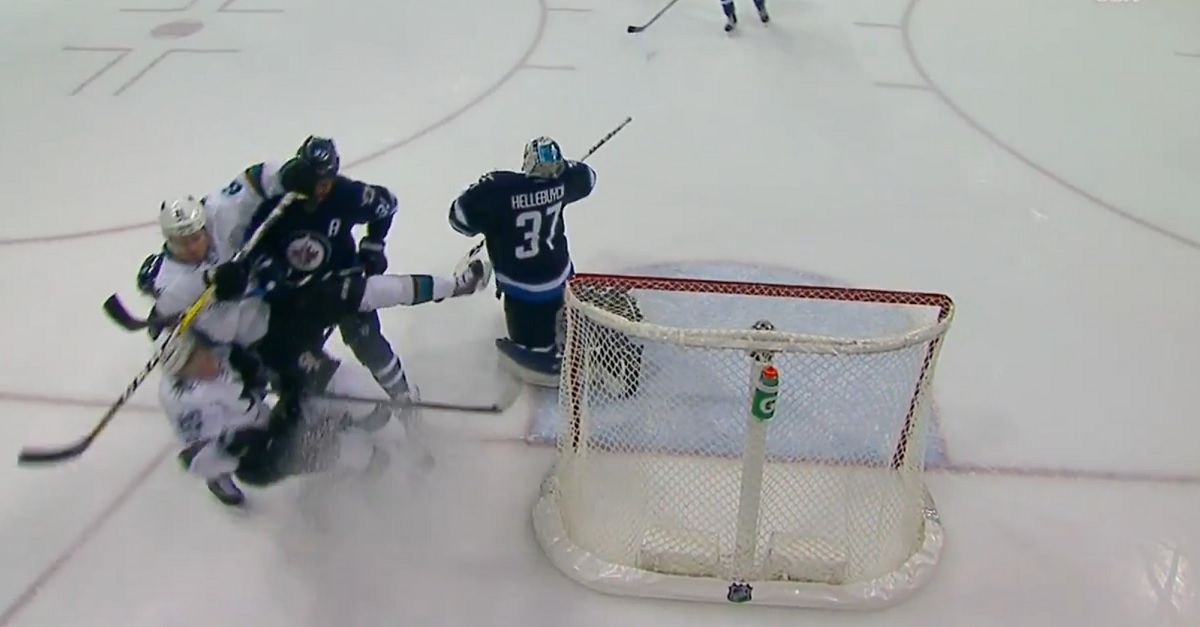 Dustin Byfuglien sends three players crashing into the boards with a single hit.