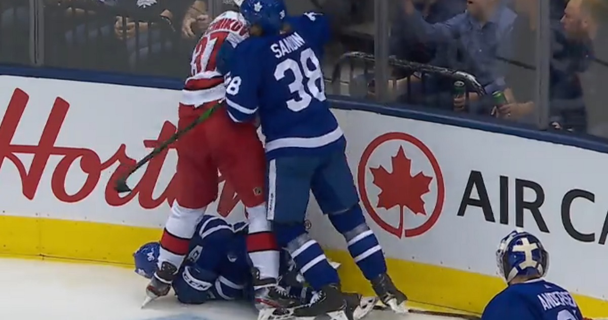 Toronto's Tyson Barrie leaves the game after being sent head first into the boards.
